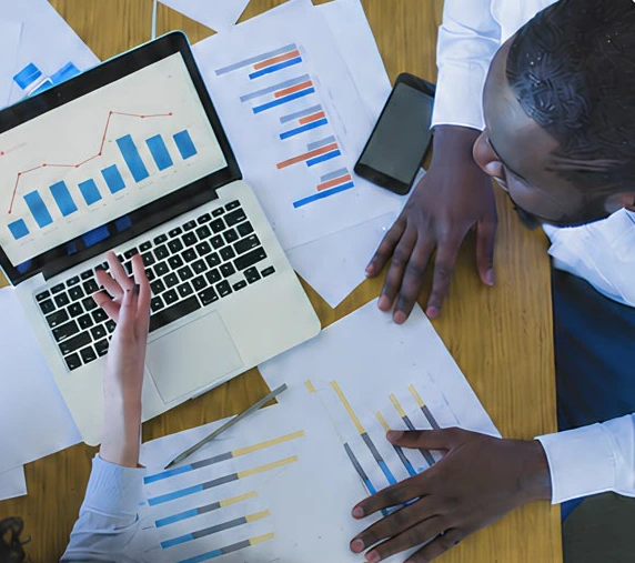 A business team reviewing financial charts around a table